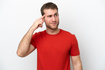 Young caucasian man isolated on white background making the gesture of madness putting finger on...