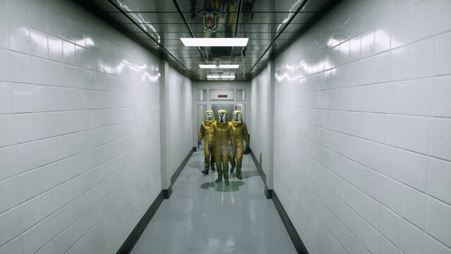 Virologists in chemical protective suits walk along the corridor of the hospital building. Doctors in special protective suits. The animation is perfect for apocalyptic or medicine backgrounds.