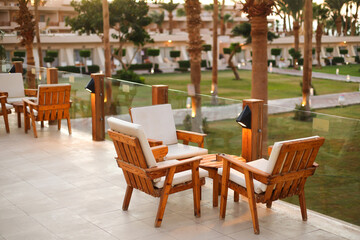 The hotel patio wood table,parasols and chairs.