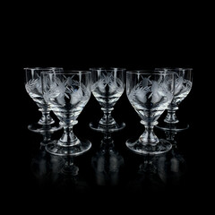 set of crystal antique wine glasses. vintage glass set of glasses for alcoholic drinks on a black isolated background