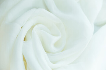 Fototapeta na wymiar a white wrinkled fabric lies in folds on a draped table.