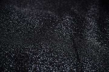 Obraz premium Black wrinkled fabric with sequins.Draped material. Glowing texture. Night sky