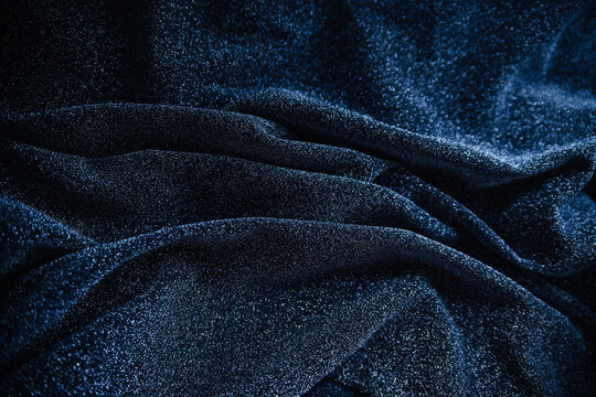Blue wrinkled fabric with sequins.Draped material.