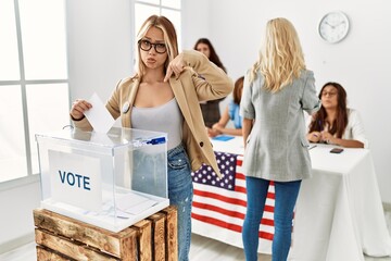 Group of young girls voting at democracy referendum pointing down looking sad and upset, indicating...