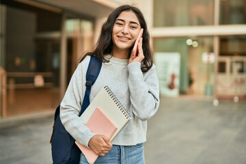 Young middle east student girl smiling happy talking on the smartphone at the city.