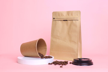 Close-up of coffee set packaging. Take away cup and pouch standing with zip lock isolated on pink...