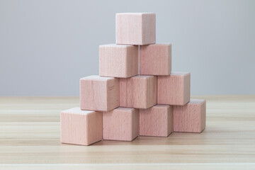 Pyramid of ten wooden cubes, on white background