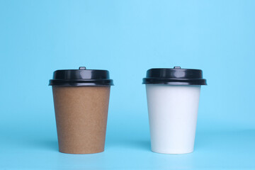 White and brown paper cup isolated on blue background. Take away cup. Realistic set mock up for branding,  template for your design, presentation, promo, ad.