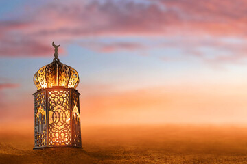 Arabic lantern glowing on desert sand