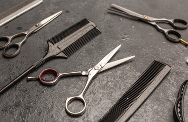 Stylish professional barber scissors, hair cutting shears on black background. Hairdresser salon...