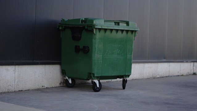 rubbish bin against industrial wall