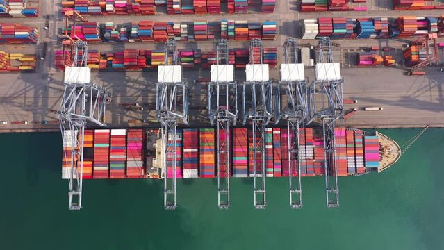 Aerial top view of container cargo ship in the export and import business and logistics international goods in urban city. Shipping to the harbor by crane in Laem Chabang, Chon Buri, Thailand