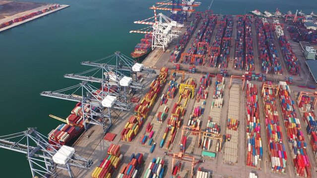 Aerial top view of container cargo ship in the export and import business and logistics international goods in urban city. Shipping to the harbor by crane in Laem Chabang, Chon Buri, Thailand