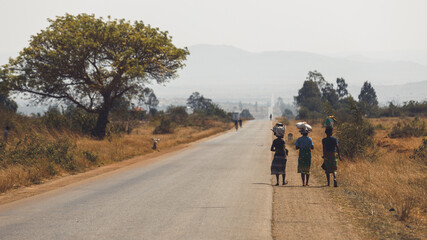 Road National 7 in the south of Madagascar, african landscape with women walking while carrying...