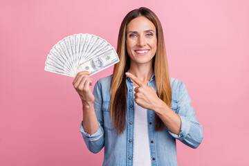 Photo of young pretty girl indicate finger cash suggest promo investment isolated over pink color background