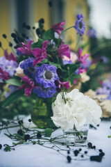 Vase with white hydrangea, pink and purple flowers