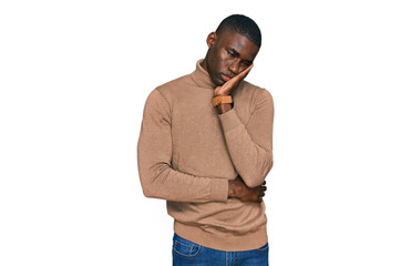 Young african american man wearing casual winter sweater thinking looking tired and bored with depression problems with crossed arms.