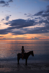 Horse ride when sunset at the beach 