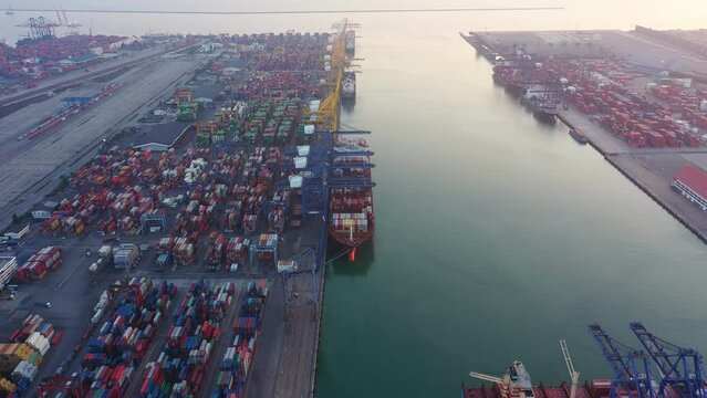 Aerial top view of container cargo ship in the export and import business and logistics international goods in urban city. Shipping to the harbor by crane in Laem Chabang, Chon Buri, Thailand