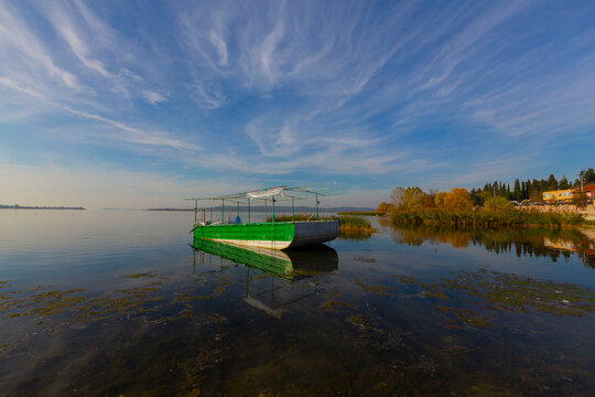 Fishing boat in the lake at magnificent sunset. Golyazi Bursa Turkey