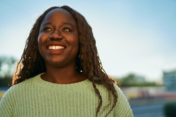 Young african woman smiling happy at the city