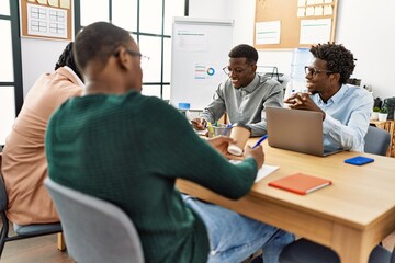 Obraz premium Group of young african american business workers smiling happy working at the office.