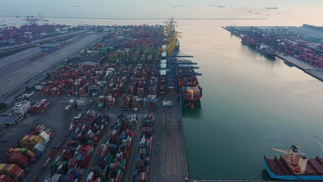 Aerial top view of container cargo ship in the export and import business and logistics international goods in urban city. Shipping to the harbor by crane in Laem Chabang, Chon Buri, Thailand
