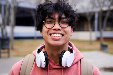 Close up shot of cheerful happy asian teenage boy looking at camera smiling. Intense look of a young man. - Powered by Adobe