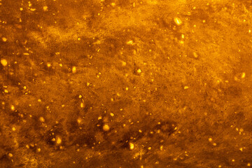 Obraz premium Background Stone wall, golden background with abstract stains of epoxy. Beautiful marble and granite texture, onyx surface. Finishing stone for the interior. Acrylic stains.