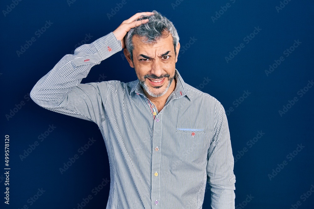 Poster Handsome middle age man with grey hair wearing business shirt confuse and wonder about question. uncertain with doubt, thinking with hand on head. pensive concept.