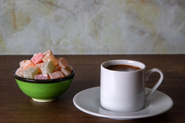 Traditional Turkish delight and Turkish coffee on a wooden background	