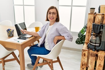 Middle age hispanic woman businesswoman reading documents at business office