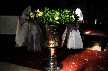 Baptismal font. Baptismal font adorned with flowers for baptism. Christian-Orthodox tradition....