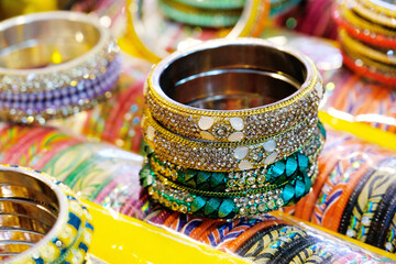 Fototapeta na wymiar 17 April 2022, Pune , India, Colorful Bangles display in Shop for women, Metal Bangles Arranged On The Shelf For Sell, Series of bangles.
