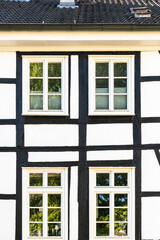 old half-timbered house facade with windows 