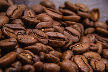 Coffee beans. Coffee beans are spread out on the surface. Roasted coffee beans background, pattern, selective focus