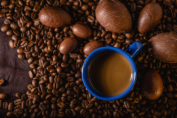 Delicious Chocolate eggs on Coffee beans background: Close-up of a beans, chocolate egg, chocolate...
