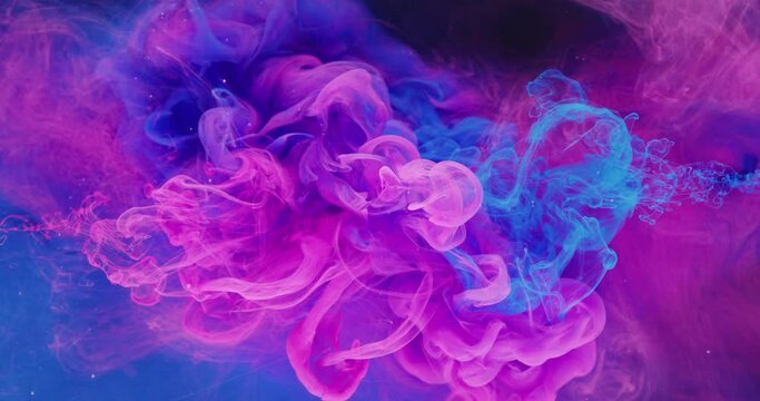 Ink color blend. Paint water drop. Transition reveal effect. Neon pink blue fluid splash on vibrant purple fume texture creative abstract background shot on Red Cinema camera 6k.
