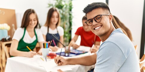 Group of people drawing at art studio.