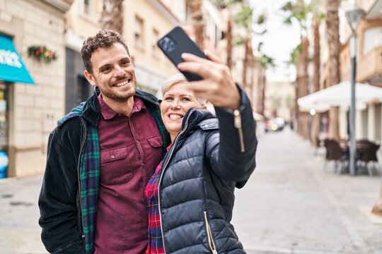 Mother and son smiling confident making selfie by the smartphone at street