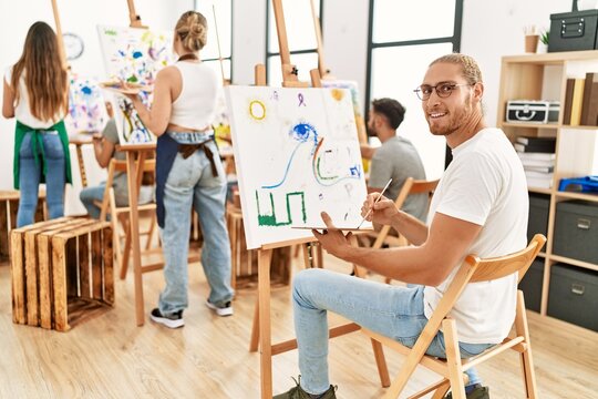 Group of young people smiling happy drawing at art studio