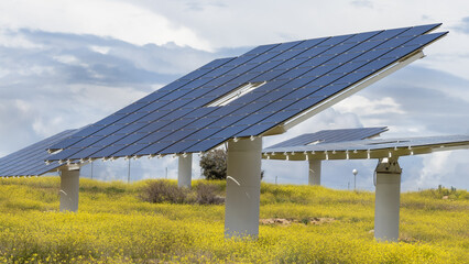 Station with rotating solar panels in a field in Spain. Solar power panels converting sunlight into electricity. Renewable energy for ecological transition