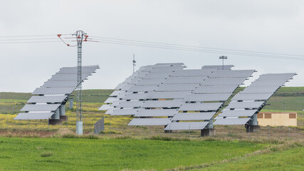 Station with rotating solar panels in a field in Spain. Solar power panels converting sunlight into electricity. Renewable energy for ecological transition