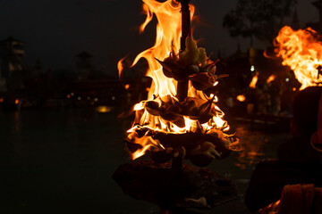burning flame of aarti pot with dark background for holy rituals at night