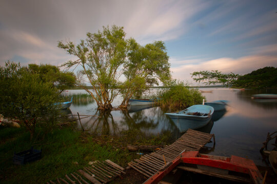 Boats stand by the lake, straws in the back. Eber Lake in Turkey.