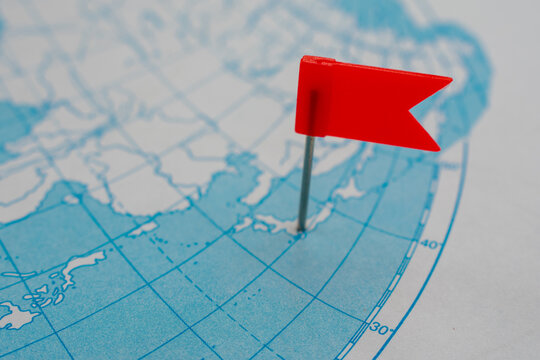 Breaking news from Japan concept. Red flag on map of Japanese islands. Earthquake or tsunami alert or some other accident attention.