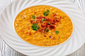 corn chowder in bowl on table, top view