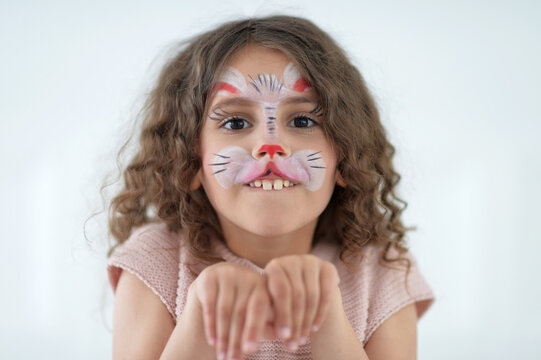 Cute little girl with face painted as rabbit
