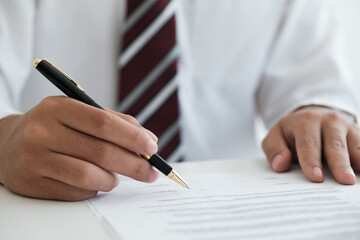 Close up businessman signing contract, partnership agreement, making deal