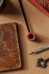 A vintage pipe and an old notebook, retro objects. The concept of a journalist or a sleuth,...